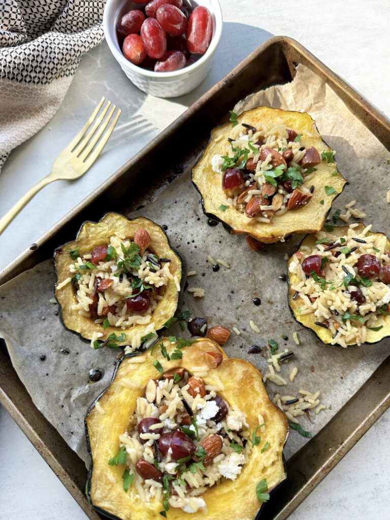 Stuffed Acorn Squash with Wild Rice, Grapes, Feta and Roasted Almonds