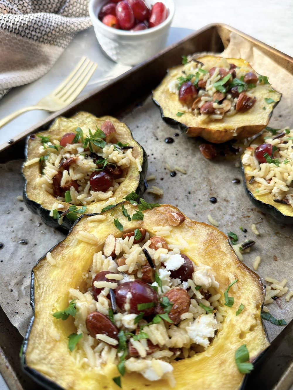 Stuffed Acorn Squash with Wild Rice, Grapes, Feta and Roasted Almonds
